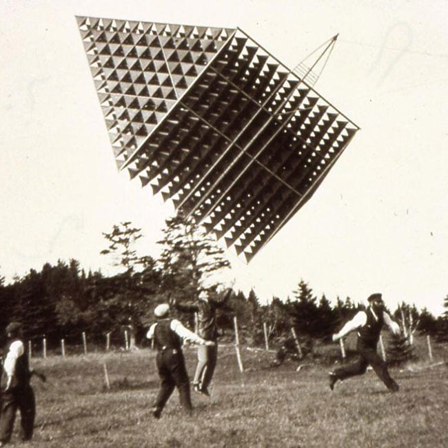 Photo of Tetrahedral Kite in a field with people around it.